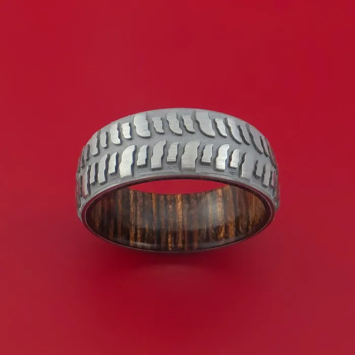 Rings Lashbrook Titanium Ring with Mud Tire Tread Pattern Inlay and Interior Hardwood Sleeve Custom Made Band Rings Lashbrook Titanium Ring with Mud Tire Tread Pattern Inlay and Interior Hardwood Sleeve Custom Made Band